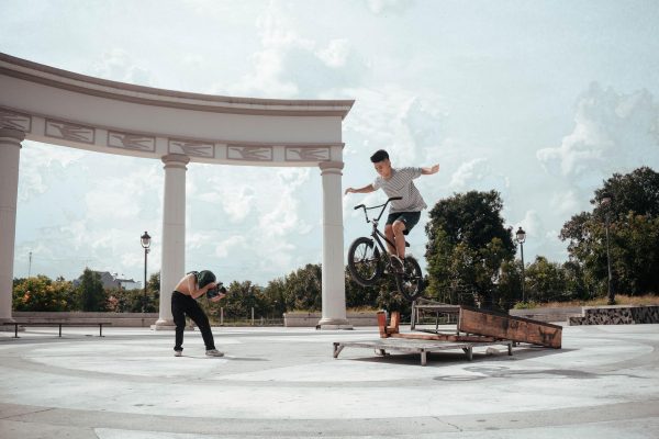 A boy performing tricks and stunts on BMX bikes